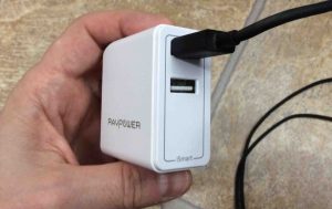 Picture of the RavPower portable USB charger with an Amazon micro USB to USB A data charge cable plugged into it.