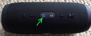 Picture of the speaker in Bluetooth discovery mode. Power button is flashing blue and highlighted.