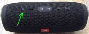 Picture of the JBL Charge 3 Bluetooth speaker, powered On, not paired. Showing its Bluetooth discovery mode button highlighted.