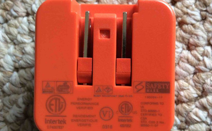 Picture of the Picture of the JBL Charge 3 rechargeable waterproof speaker AC power adapter, mains side view, Showing the safety labels.