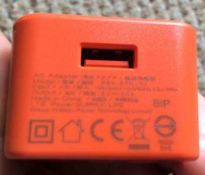 Picture of the JBL AC power supply adapter. Showing the USB output port side, with specs printed on that side. JBL Flip 2 charger replacement.