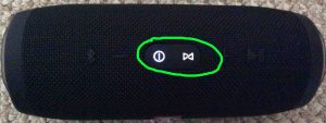 Picture of the JBL Charge 3 speaker during hard reset. Showing the glowing -Power- and -Connect- buttons lighted and circled.