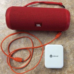 Picture of the JBL Flip 3 battery operated speaker, with its USB charging cable along with an iClever 3 port USB wall charger. JBL Flip 3 Charge Time.