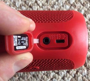 Picture of the JBL Flip 3 Bluetooth portable speaker, showing the AUX In and USB port compartment.