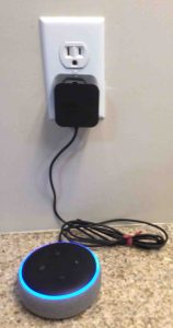 Showing the smart speaker powering up, with its AC adapter plugged into standard wall outlet.