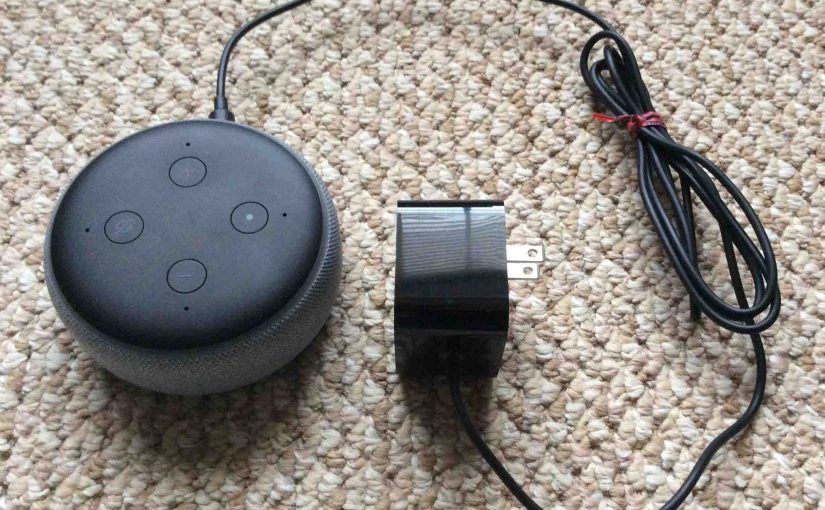 Picture of the Amazon Echo Dot gen 3 smart speaker along with its AC wall adapter.