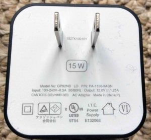Picture of the Amazon Echo Dot 3rd gen power adapter, model # GP92NB, for the Generation 3 Alexa Echo Dot speaker, showing its plug and specs label side. Amazon Echo Dot 3rd gen power adapter specs.