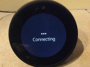 Picture of the Echo Spot wireless smart speaker, displaying its Connecting screen, while it attempts to connect to the current WiFi network.