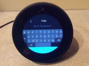 Picture of the Alexa Echo Spot wireless speaker, displaying its WiFi Password Entry screen, with blank field, no password entered yet.