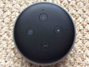 Picture of an Amazon Alexa Echo Dot speaker, top view, showing all its buttons.. 