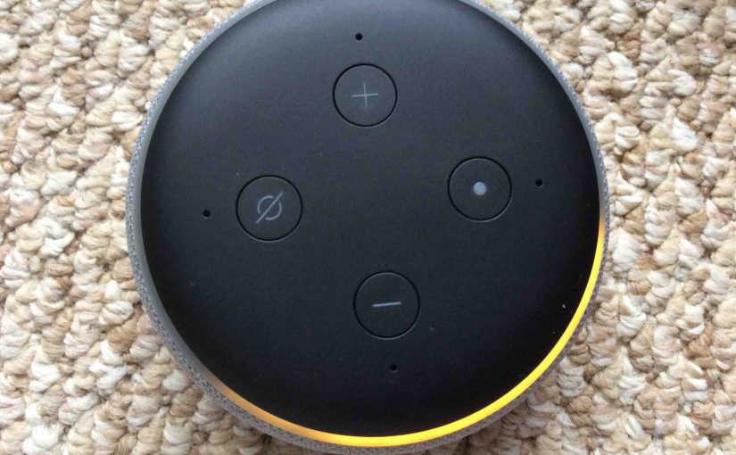 Picture of the Amazon Alexa Echo Dot 3rd Generation speaker, shown in Setup mode, light ring orange and spinning.