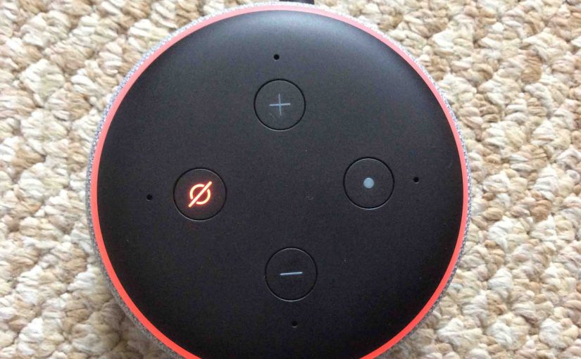 Picture of the Amazon Echo Dot 3 speaker, muted, showing its light ring and Mic Off On button glowing red.
