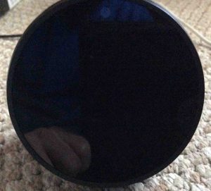 Picture of the Echo Spot smart speaker with dark screen as it power cycles.