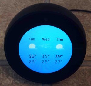 Picture of the Amazon Echo Spot speaker, front view, showing the local weather.