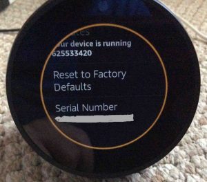 Picture of the Echo Spot speaker, showing orange light ring as Factory Reset operation starts.
