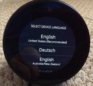 Picture of the Amazon Echo Spot Alexa speaker, displaying its Select Device Language screen. How to Factory Reset Alexa.
