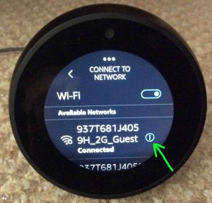 Picture of the Echo Spot Alexa speaker, displaying its -Connect To Network- page with a connected WiFi network showing, with its Information button highlighted. How to Find Echo Spot IP Address.
