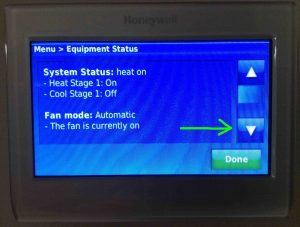 Picture of the Honeywell WiFi thermostat model RTH9580WF, displaying its -Equipment Status- screen with the -Scroll Down- button highlighted.
