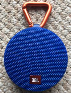 Picture of the JBL Clip 2 Bluetooth speaker, front view, vertical orientation.
