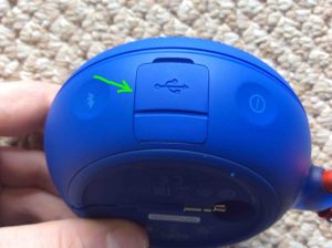 Picture of the speaker's right side panel, showing the closed USB charging port door highlighted. 
