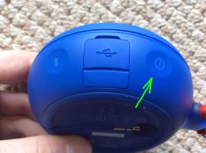 Picture of the JBL Clip 2 speaker, side view, showing the Power button highlighted.