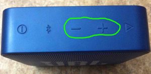 Picture of the JBL Go 2 wireless speaker showing its Volume UP and DOWN buttons circled in green.