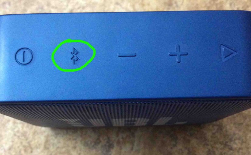 Picture of the JBL Go 2 wireless speaker, top view, showing its Bluetooth Pairing button circled.