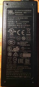 Picture of the AC charger, bottom view, showing the specifications label.