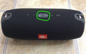 Picture of the speaker with its -Power- and -Connect- buttons glowing pale during reset, and circled.