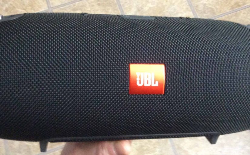 Picture of the JBL Xtreme Bluetooth speaker, front view, held in hand.