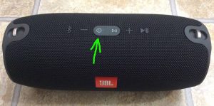 Picture of the Jspeaker powered OFF, showing its dark Power button highlighted. 