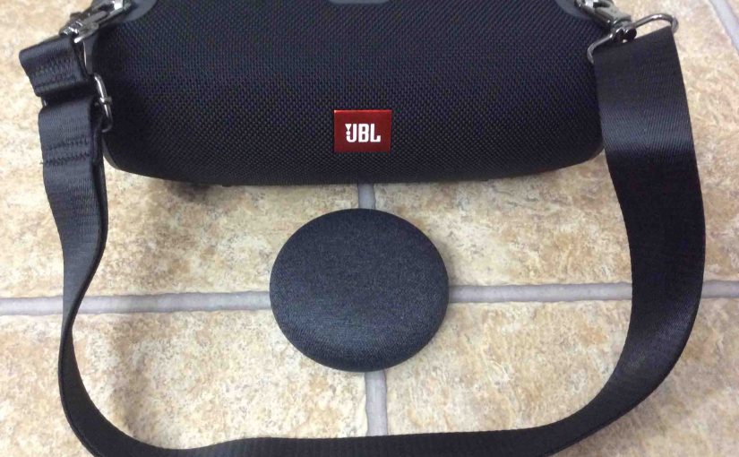 Picture of the Xtreme JBL Bluetooth speaker and its carrying strap, along with the Mini Google Home smart speaker.