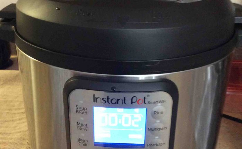 Picture of the Instant Pot smart WiFi pressure cooker, front view while operating in -Keep Warm- mode.