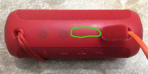 Picture of the speaker, connected to charger, now fully charged, showing all battery gauge lights OFF, and circled.