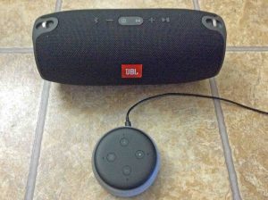Picture of a JBL Xtreme speaker with an Alexa Echo Dot 3 smart speaker. Alexa features list.
