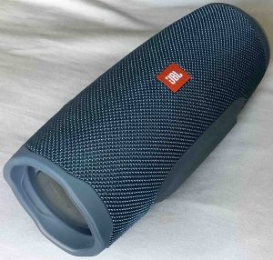 Picture of the JBL Charge 4 portable speaker, front left view, showing the passive radiator on the left side.