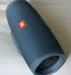Picture of the JBL Charge 4 waterproof speaker, front right view, showing the bass radiator on the right side. 