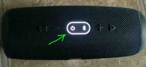 Picture of top of the Charge 4 power bank speaker, showing the Bluetooth and Power buttons along with the enclosing oval ring lit, and highlighted.