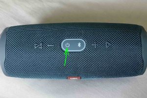 Picture of the JBL Charge 4 power bank speaker, top view, showing the Power button highlighted.