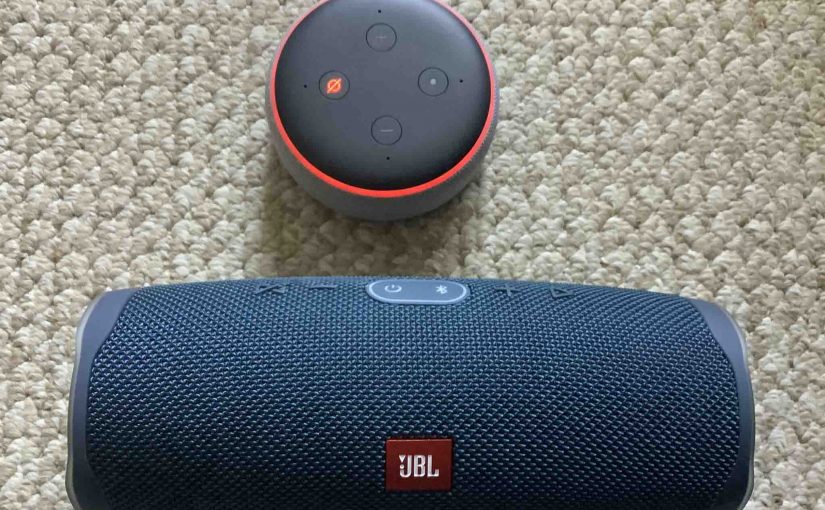 Alexa Echo Dot 3 alongside a JBL Charge 4 Bluetooth speaker.
