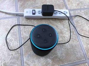 Top view of this Alexa speaker, shown connected to AC power and booting.