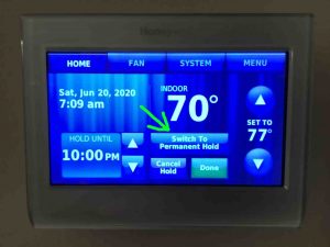 Picture of a typical Honeywell thermostat displaying its -Hold Options- screen, with the -Switch to Permanent Hold- button highlighted.
