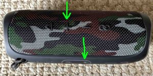 Picture of the button panels on the JBL Flip 5 speaker, showing the -Volume UP- and -Bluetooth- controls highlighted.