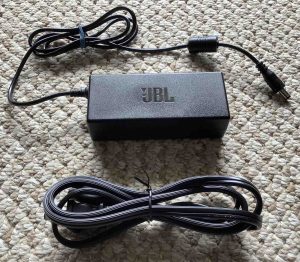 Picture of the JBL Xtreme 2 charging adapter power supply and AC cable.