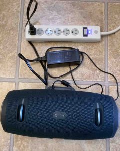 Top view of the JBL Xtreme 2 speaker, connected to power, and charging.