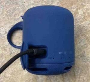 Sony SRS XB10 Bluetooth speaker with the charging cable inserted.