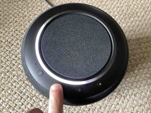 Top view picture of the speaker, showing the -Volume DOWN- button being pressed.