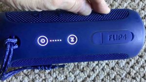 Picture of the JBL Flip 4 speaker -Volume Down- and -Bluetooth- buttons pressed, and all Lights turning ON briefly as a result.