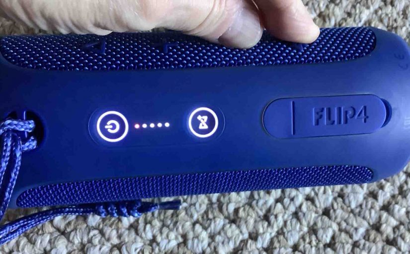 Picture of the JBL Flip 4 speaker -Volume Down- and -Bluetooth- buttons pressed, and all Lights turning ON briefly as a result.
