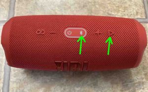 Showing the -Bluetooth- and -Play-Pause- buttons on the JBL Charge 5 speaker.